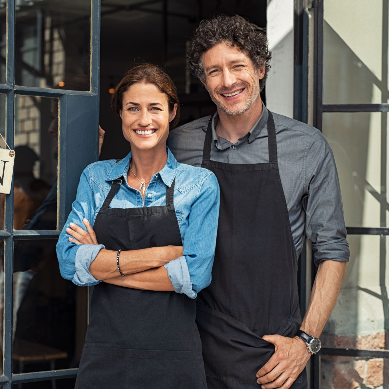 Two business owners, a man and a woman, standing together